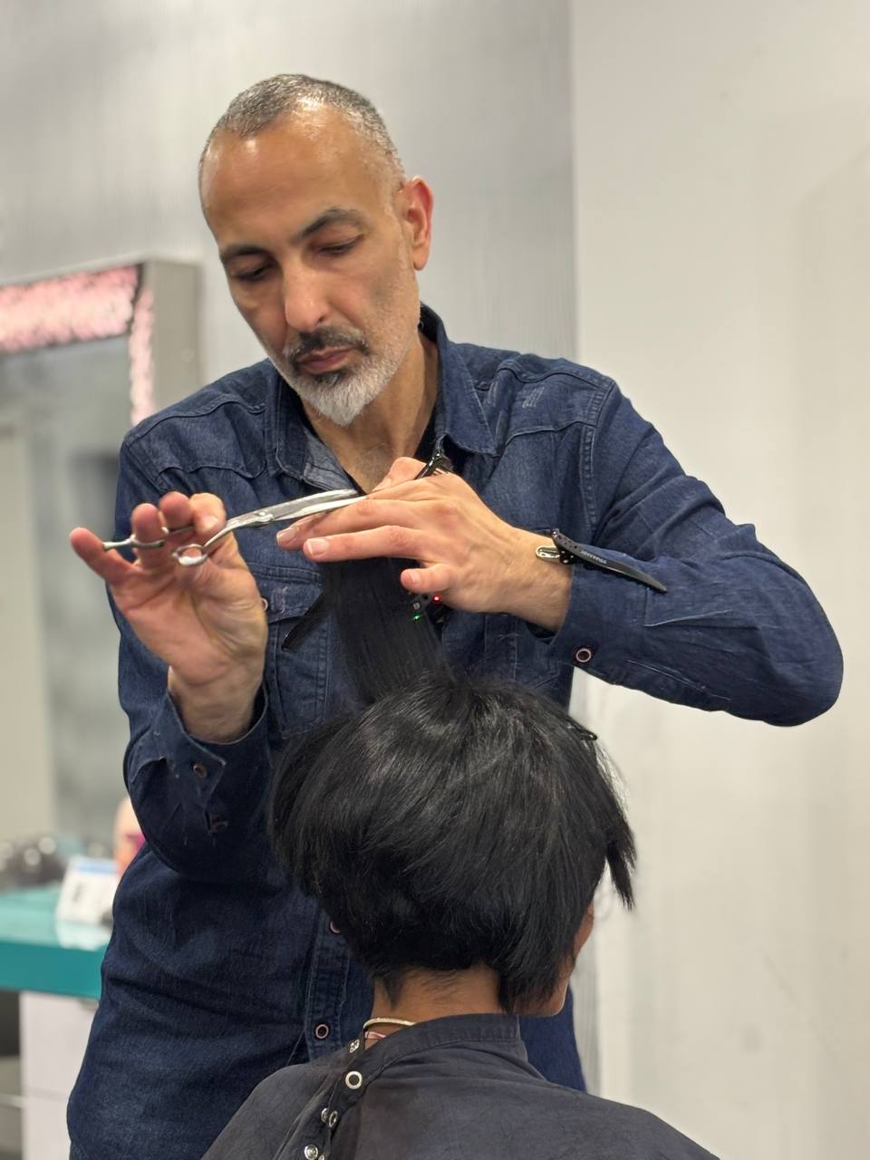 Master stylist Yaniv Levy cutting a client's hair at Williamsburg Salon in Brooklyn