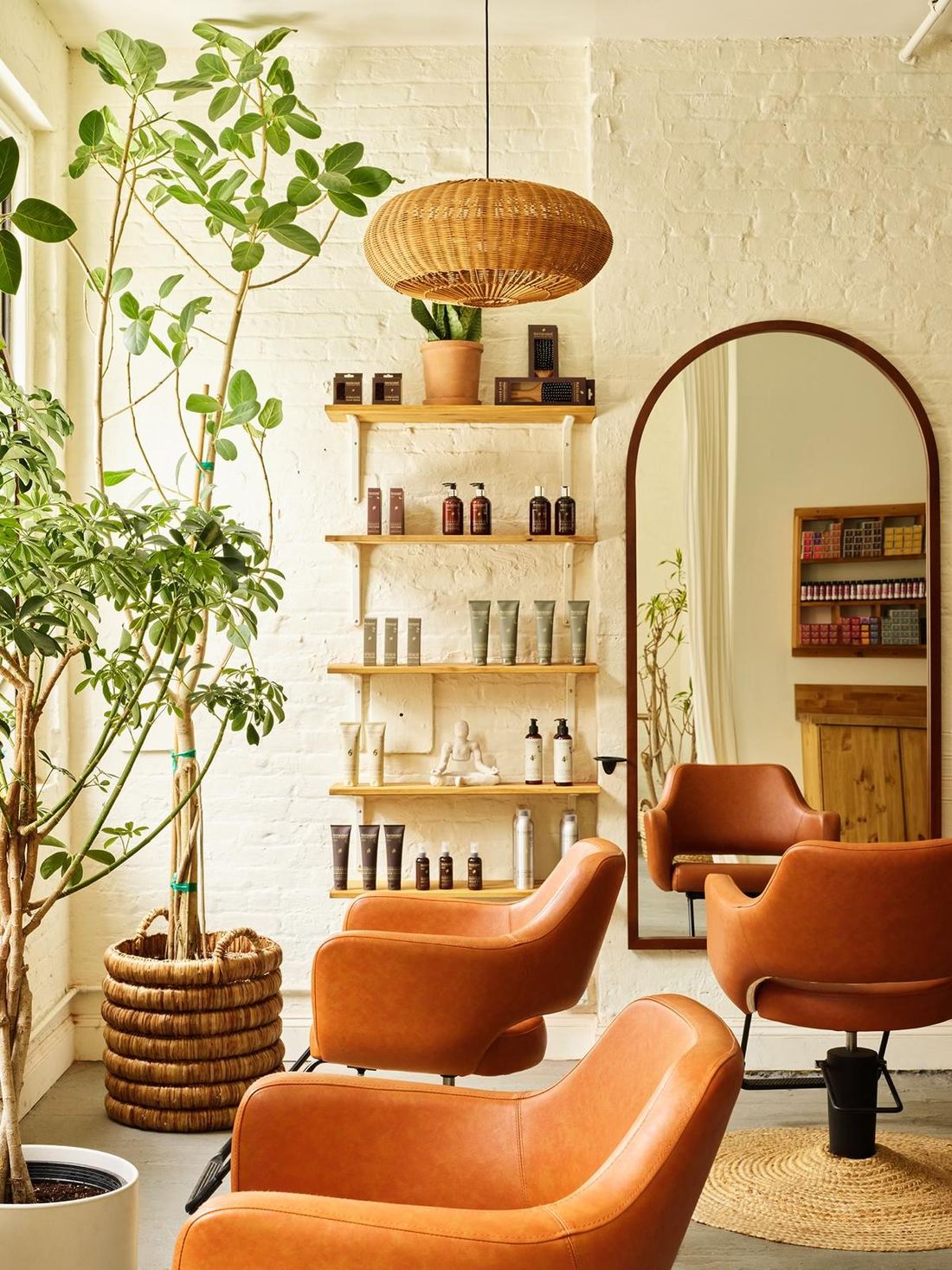 The Williamsburg Salon studio lounge at 97 South 6th Street, Brooklyn, with styling chairs, product shelves and an arched mirror